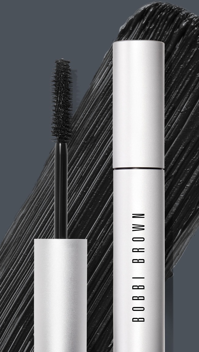 Close up of Smokey Eye Mascara with swatch behind on top of a dark grey background
