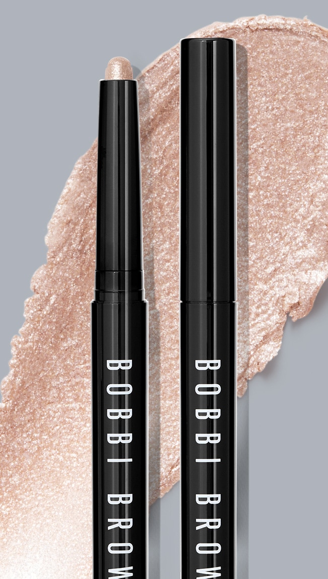 Close up of Long-Wear Cream Shadow Stick with swatch behind on top of a soft-grey background