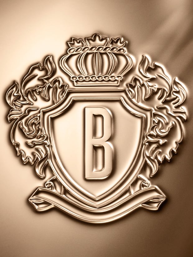 Bobbi Brown crest icon embossed in gold, matalic foil